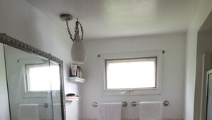 A bathroom with two sinks, a large mirror, a window, and a pink bathtub. - 4BR in Black Creek, near Green Bay Appleton, EAA, hunt, fish, raft, snowmobile (Black Creek)