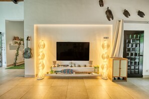 Ein modernes Wohnzimmer mit Flachbildfernseher, Kamin und Dekorationselementen.