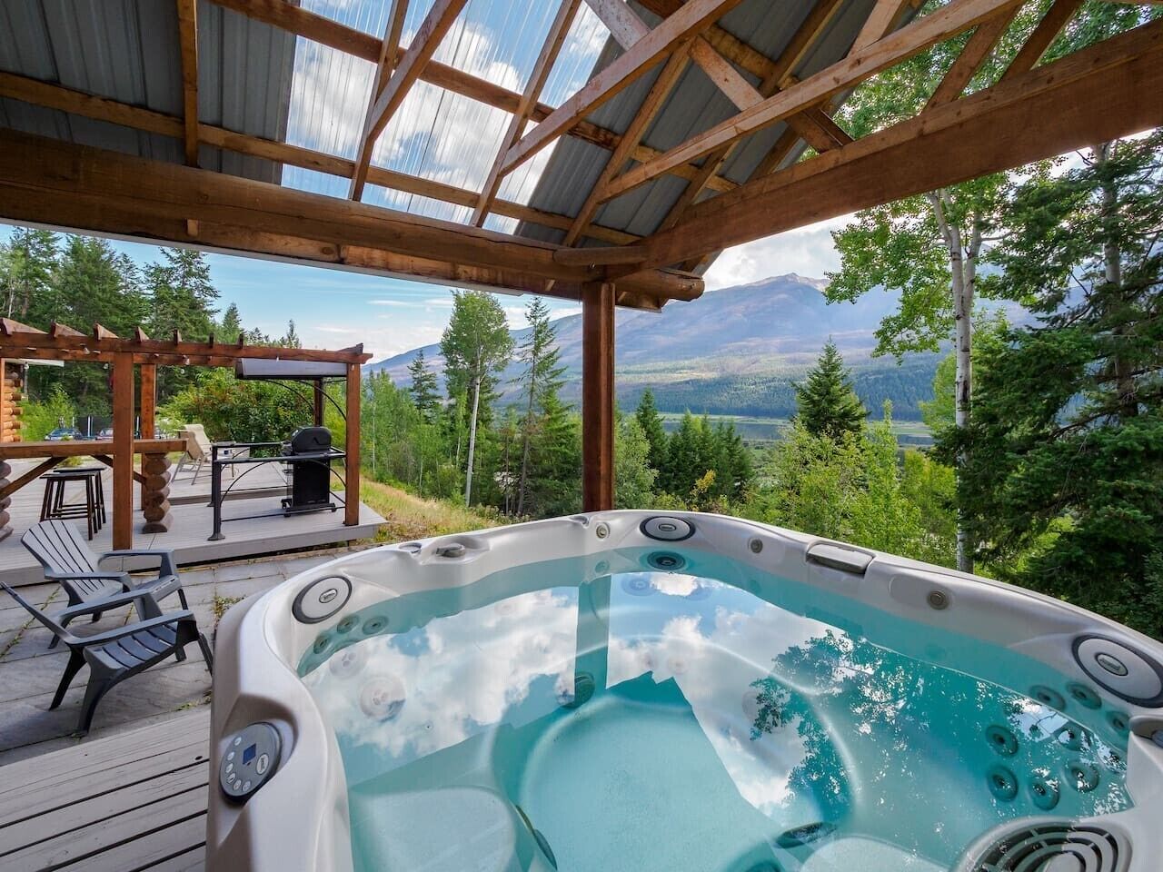 A hot tub with a view of mountains and trees.