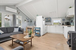 A modern living room with a sofa, coffee table, and a fireplace. - Lovely, well-designed holiday home for 6 (Hejls)