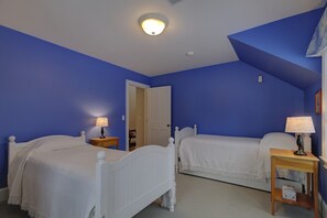 A bedroom with two single beds, white bedding, and bedside lamps. - Lakefront Estate | Private Beach | Dock | Luxury Retreat (Alton)