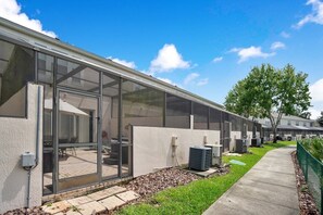 A row of modern, single-story buildings with large windows and air conditioning units. - 3BR/3BA Resort Townhome, 3 Ensuite Baths, Mins to Parks, Mins to Hospitals (Kissimmee)