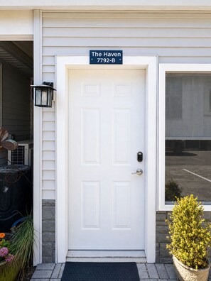 A white door with a sign reading 'The Haven 7792-B' above it. - The Haven - Downtown Egg Harbor Retreat (Egg Harbor)