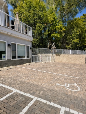 A paved parking area with a wheelchair-accessible space marked by a symbol.