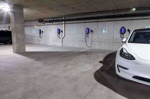 A parking garage with electric vehicle charging stations.
