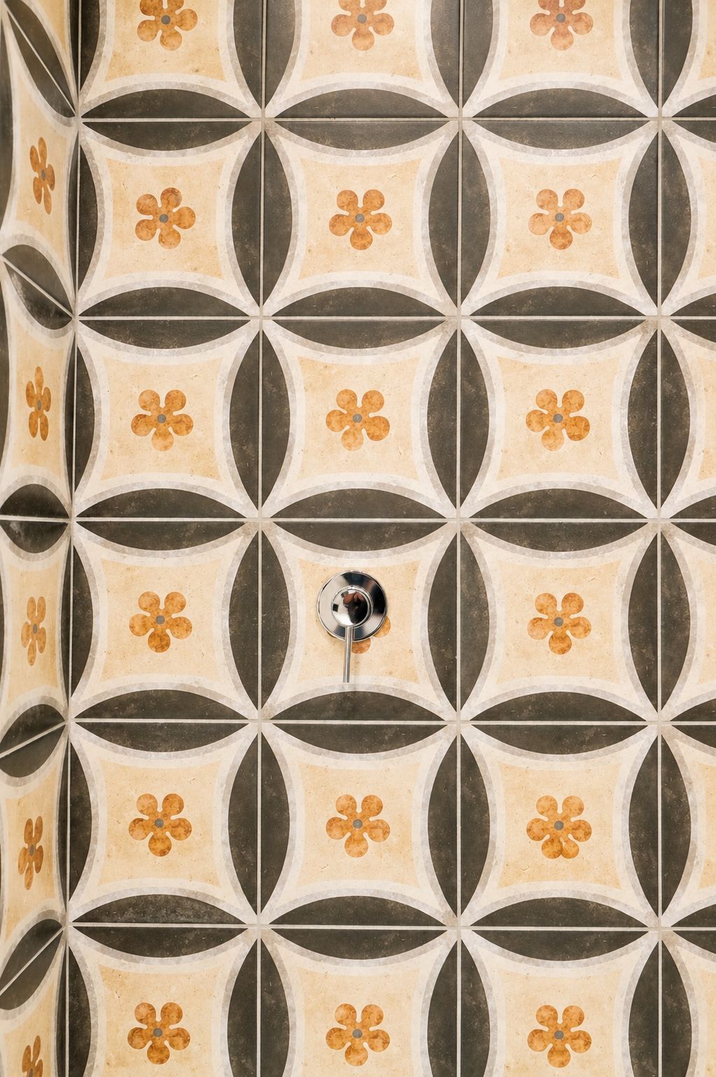 A tiled wall with a geometric pattern of circles and lines.