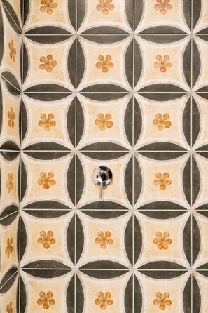 A tiled wall with a geometric pattern of circles and lines. - Caramanna Studio Apartment (Bologna)