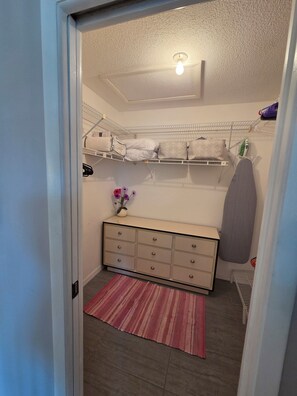 A compact bedroom with a bunk bed, a dresser, a vanity, and a small ironing board. - Manasota Key FI Getaway (Englewood)