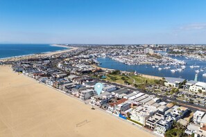 A coastal town with a marina, sandy beach, and residential buildings. - West Oceanfront Oasis 3-4-5-6-9 (Newport Beach)
