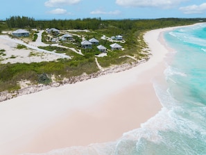 A coastal resort with multiple beachside cottages, a sandy beach, and a clear view of the ocean. - Bohemia Bunkhouse - Steps to Pink Sand, Heated Pool (Governor's Harbour)