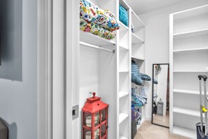 A storage closet with shelves, a red lantern, and a mirror. - Snowbird Ready | Gated Pool Villa | Bonita (Bonita Springs)