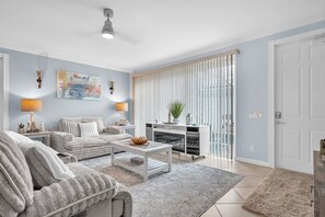 A modern living room with a sofa, coffee table, and decorative lamps. - Bonita 3BR | Pool + Tennis | Monthly Min (Bonita Springs)