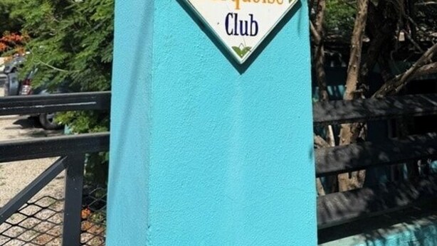 A turquoise-colored structure with a sign that reads 'Turquoise Club.'