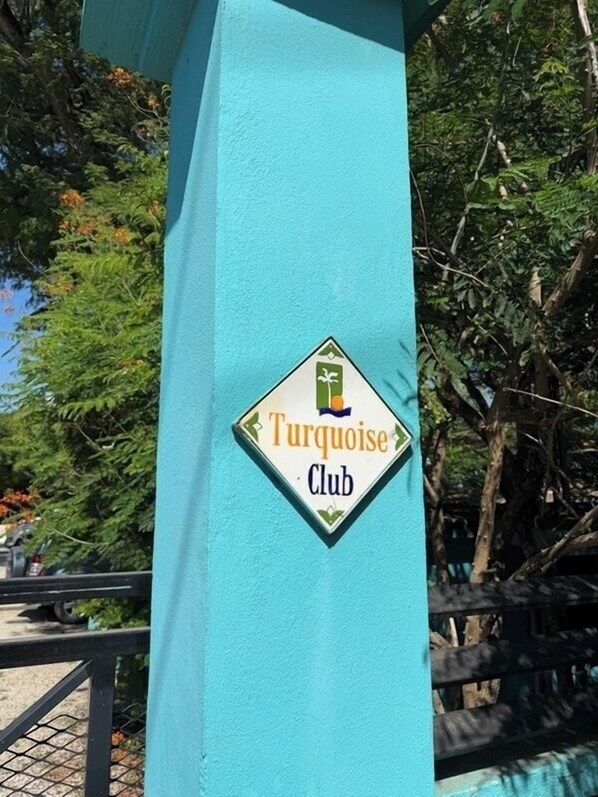A turquoise-colored structure with a sign that reads 'Turquoise Club.'
