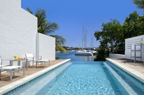 A swimming pool with a view of boats and palm trees. - Cozy condo sleeps 4 in upscale Oyster Pond region,AC throughout. 2nd Club Access (Oyster Pond)