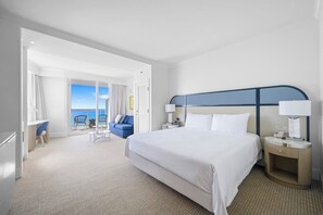 A hotel room with a bed, bedside tables, a desk, a chair, and a view of the ocean. - Stunning Ocean View Studio at Tresor Fontainebleau Miami Beach (Miami Beach)