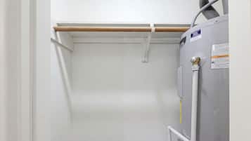 A room with a white door, a radiator, and a water pipe.