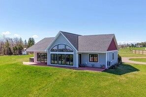 A single-story house with a large front porch and a garage. - SaltWind Retreat | Bay Views Near Cavendish (Kensington)