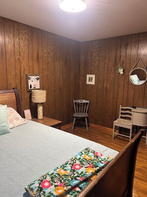 A bedroom with a bed, a chair, a desk, and a hanging chair. - Whispering Willow Ranch House near Ethridge-home of the Amish Community (Lynnville)