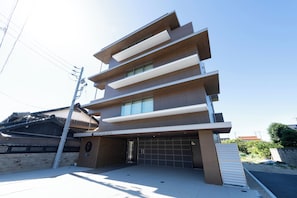 A modern hotel with a multi-story structure, a flat roof, and a visible entrance.