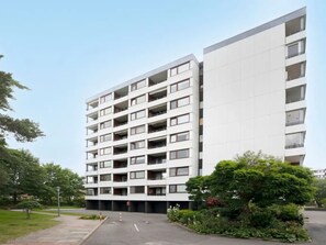 A multi-story residential building with balconies and a parking area. - Meeresblick Ankerplatz 84 by Interhome (Kellenhusen)