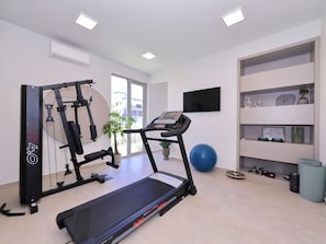 A home gym with a treadmill, weight bench, and exercise ball. - 5* Luxury villa La Casa with heated pool and sauna by Interhome (Zadar/Bibinje)