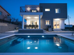 A modern two-story house with a swimming pool, outdoor seating, and a barbecue area. - Villa IviCasa with pool by Interhome (Murvica)