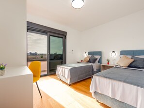 A modern bedroom with two beds, a desk, and a chair. - Seaview Villa Mar with pool, jacuzzi and sauna by Interhome (Privlaka)