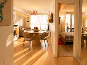 A modern living space with a dining area, a sofa, a bed, and a kitchen. - The Imperial Waterfront Escape (Toronto)