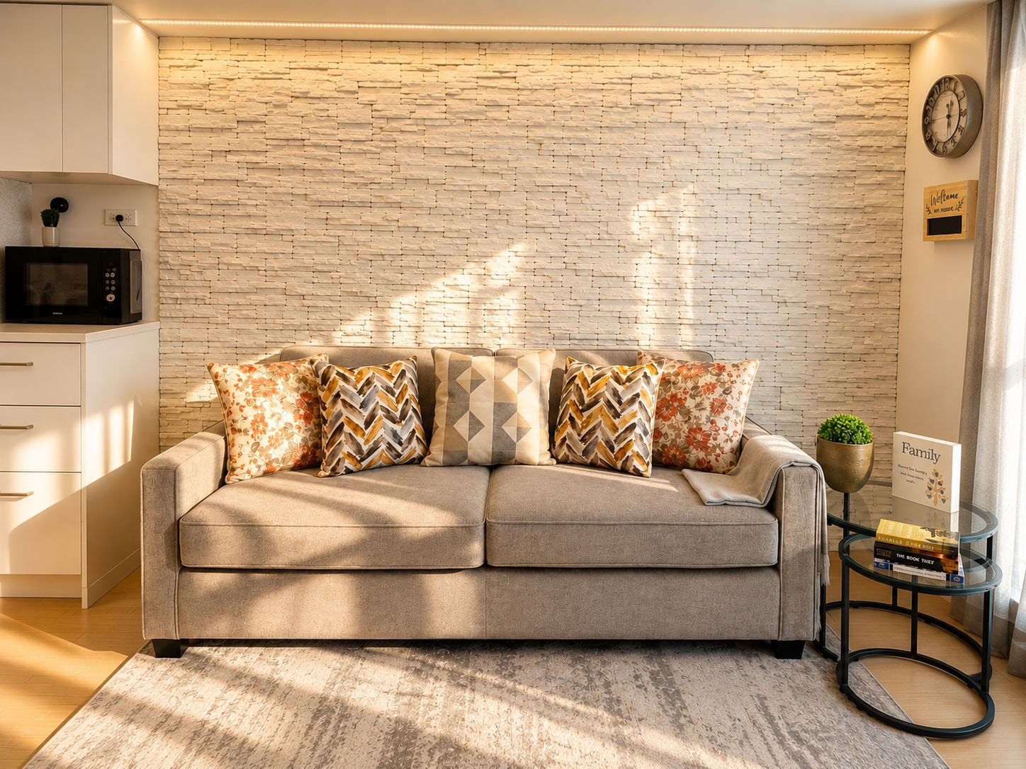 A modern living room with a stone-textured wall, a sofa with patterned cushions, a small side table with a plant, and a clock on the wall.