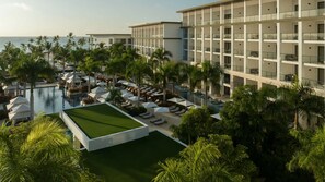 A resort with a pool, lounge areas, and a view of the ocean. - Unforgettable Cap Cana Retreat for All Ages (Punta Cana)