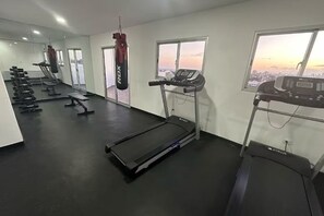 A gym with treadmills, a punching bag, and weight machines.