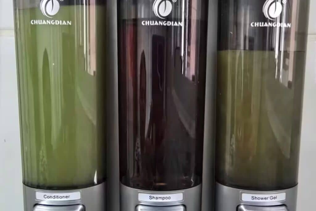 Three bottles of CHUANGDIAN personal care products.