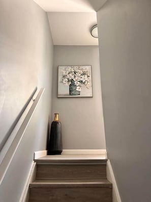 A staircase with a framed artwork above it. - Brand New Stunning Home 3 min to Niagara Falls (Niagara Falls)