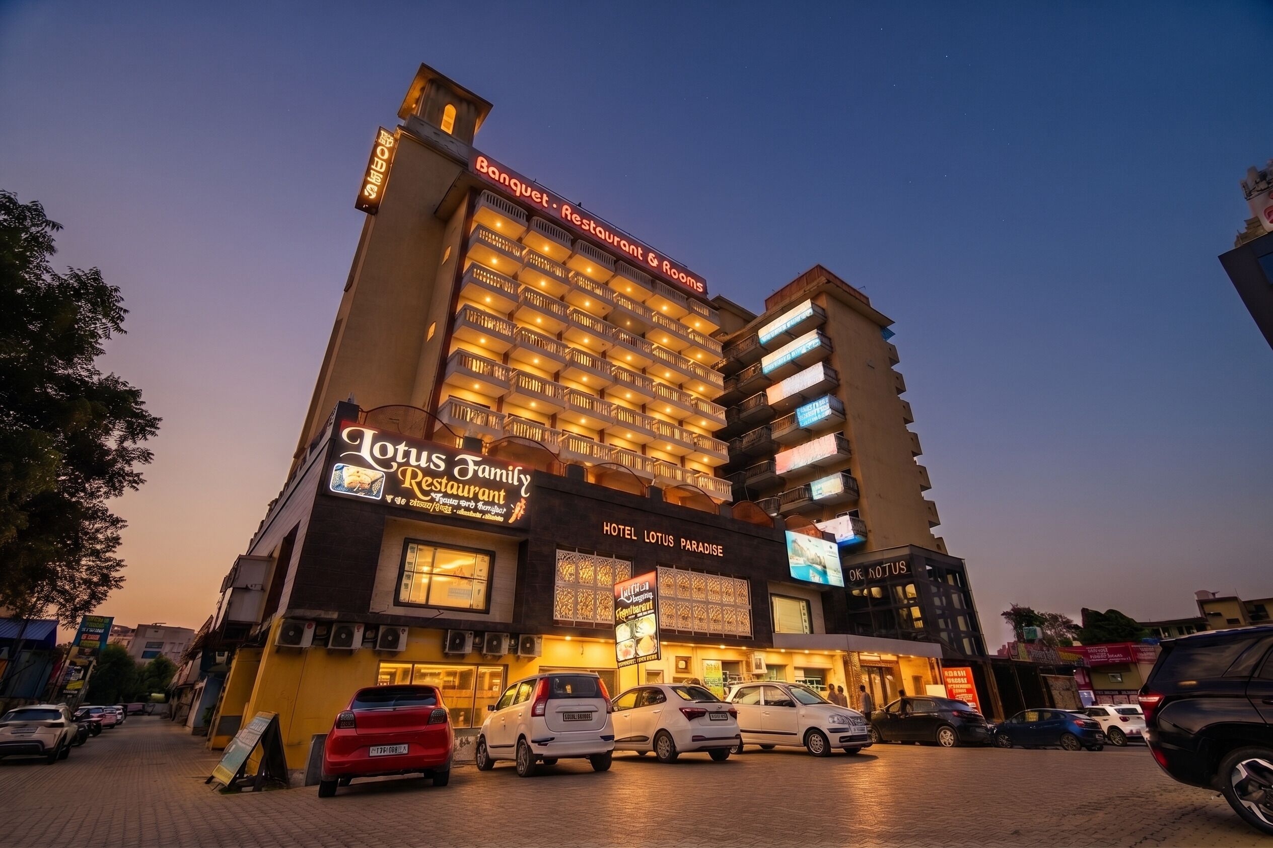 A hotel with multiple floors, a restaurant named 'Lotus Family Restaurant,' and a sign for 'Banquet - Restaurant & Rooms.'