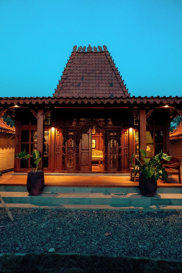 A traditional building with a tiled roof and ornate wooden doors.