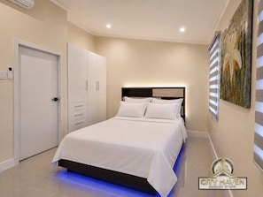 Iron/ironing board, free WiFi, bed sheets - City Haven | Luxurious 2BR Home • Modern & Secure (Portmore)