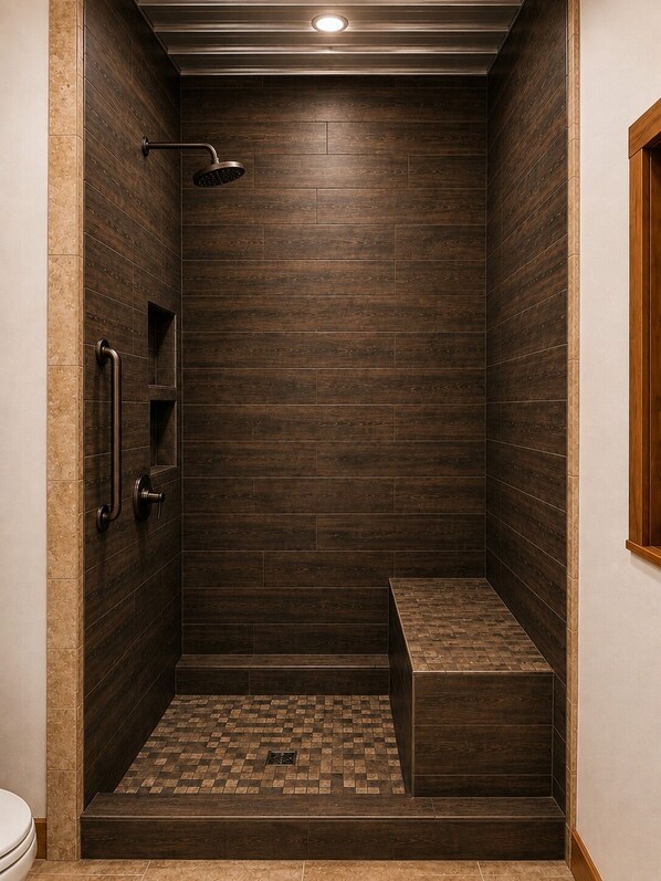 A shower area with a bench, a handrail, and a tiled floor.