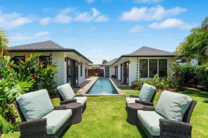 A pool area with two houses, each with a balcony and a small pool. - Luxury Villa in Sunny Poipu with a heated pool, A/C and open floor plan. (Koloa)