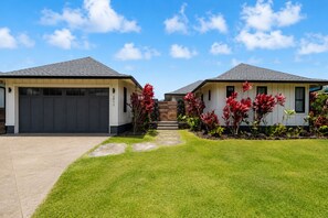 A residential property with two houses, a driveway, and a well-maintained lawn. - Luxury Villa in Sunny Poipu with a heated pool, A/C and open floor plan. (Koloa)