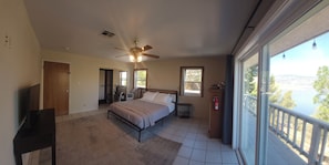 A bedroom with a bed, a ceiling fan, a window, and a view of a lake. - Gauche Point Guest House
Breathtaking Scenic Lake View (Mountain Mesa)