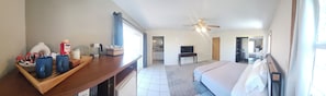 A hotel room with a bed, a desk with a coffee maker, a television, and a ceiling fan. - Gauche Point Guest House
Breathtaking Scenic Lake View (Mountain Mesa)