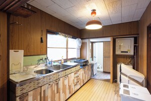 Una cocina con gabinetes de madera, un fregadero, una estufa y un refrigerador.