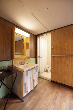 Une petite salle de bain avec un lavabo, un miroir et des meubles en bois.