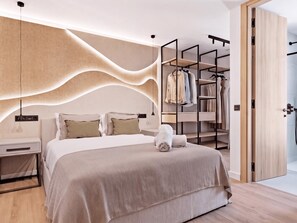 A modern bedroom with a bed, bedside tables, a wardrobe, and a walk-in closet. - Villa Confort by Vacation Marbella (Estepona)