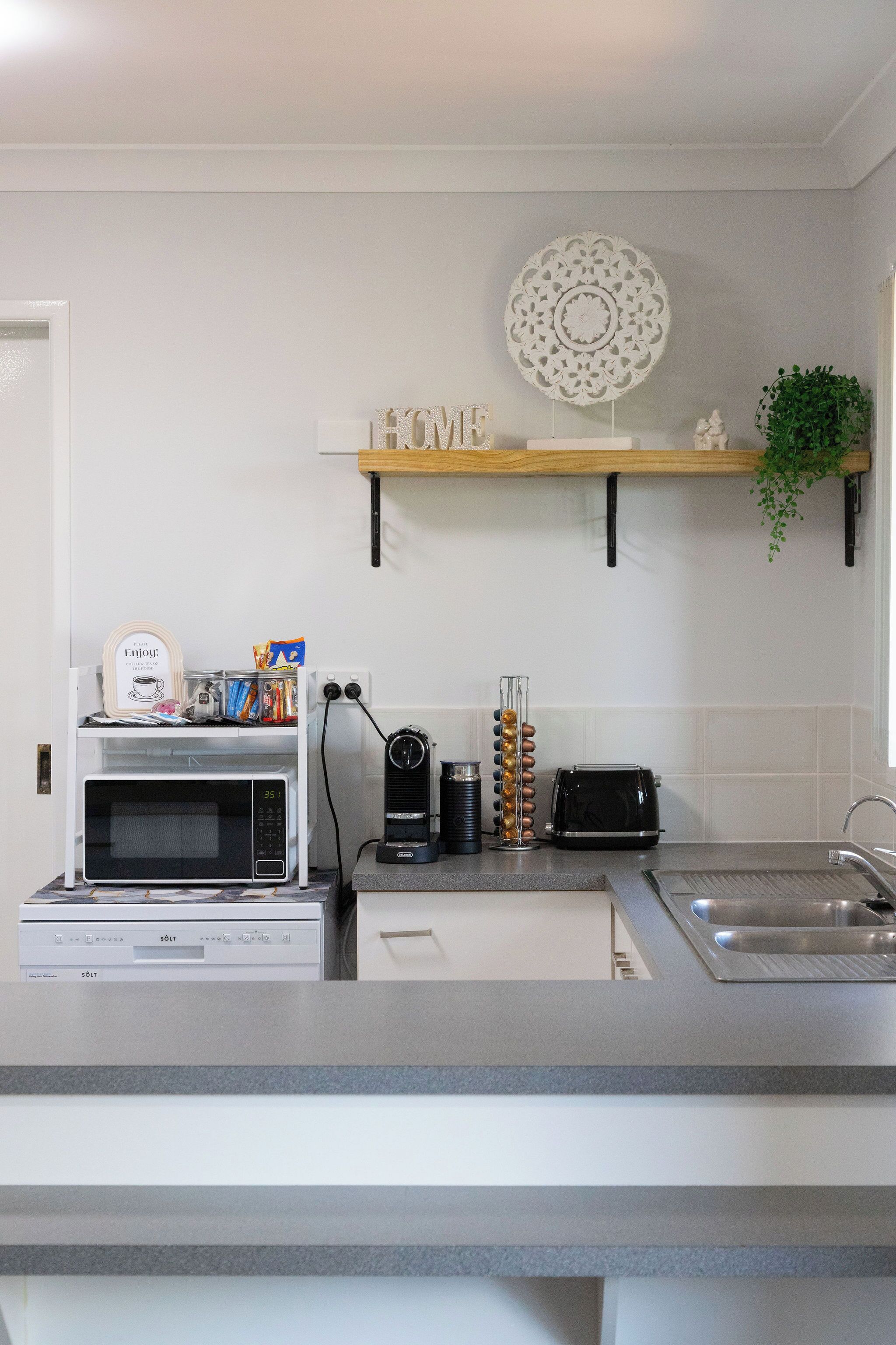 A kitchen with a microwave, toaster, and coffee maker on the counter.