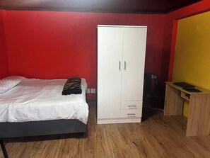 A bedroom with a bed, a wardrobe, and a desk. - Room-spacious House Rental With Private (Cape Town)