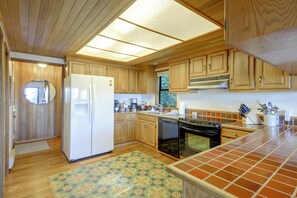 A kitchen with wooden cabinets, a refrigerator, a stove, and a dishwasher. - Hood Canal Views & Near Alderbrook Resort! (Union)