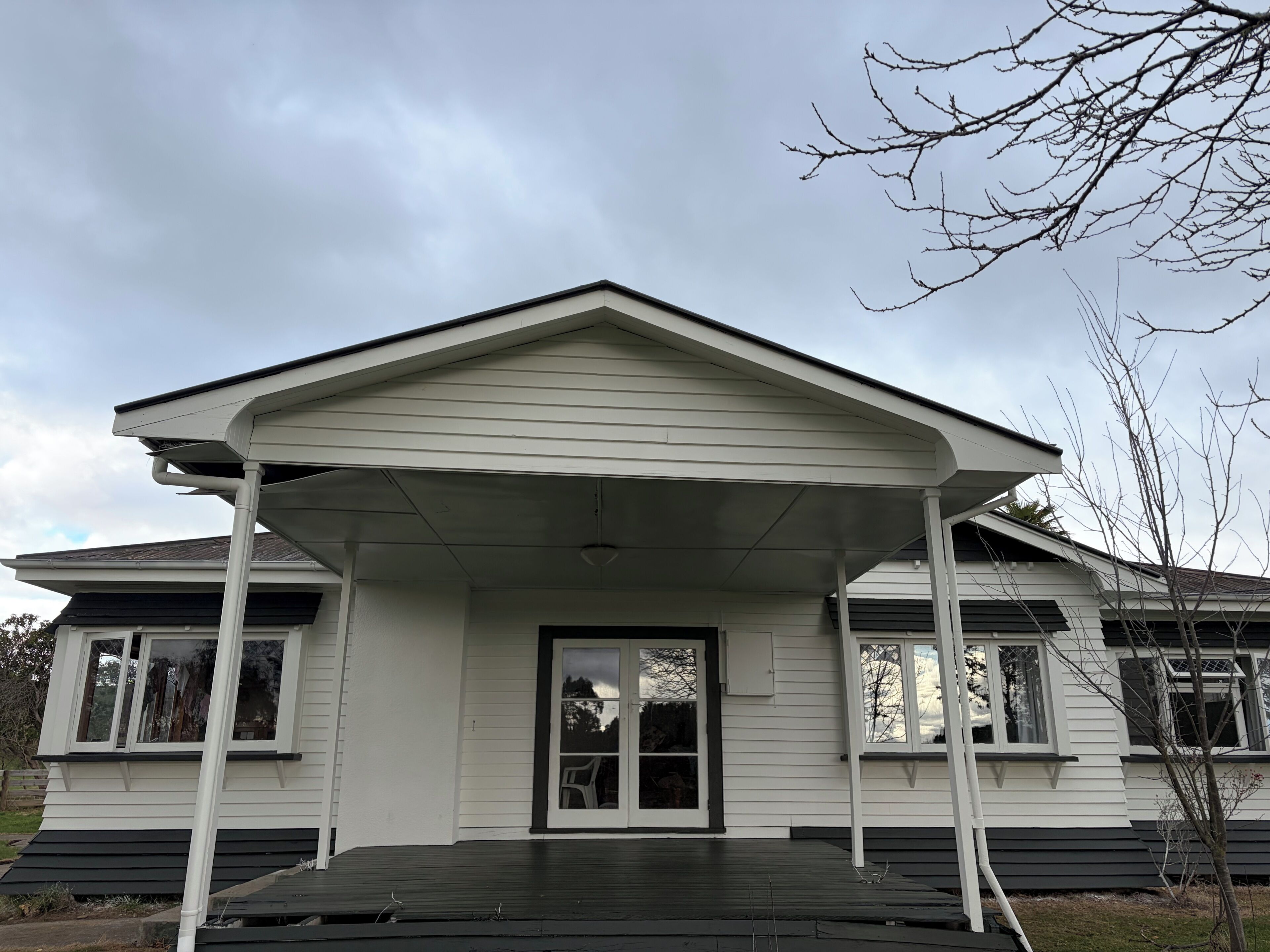 A house with a covered porch, a front door, and a garage door.