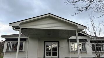 A house with a covered porch, a front door, and a garage door.